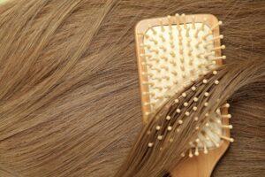 Female hair with hair brush, close up